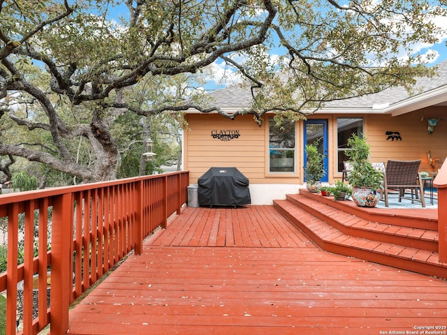 wooden terrace with a grill