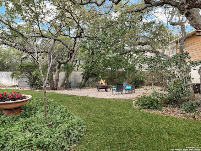 view of yard featuring a patio, a fire pit, and fence private yard