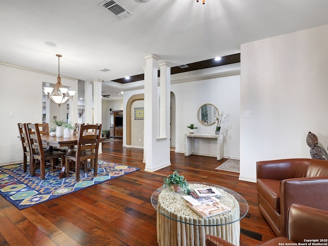 dining space featuring visible vents, decorative columns, baseboards, and hardwood / wood-style floors