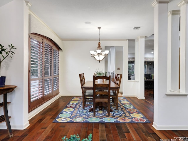 dining space with hardwood / wood-style floors, visible vents, and ornate columns