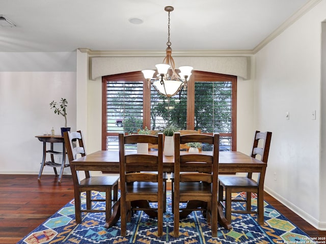 dining area featuring a notable chandelier, wood finished floors, visible vents, and baseboards