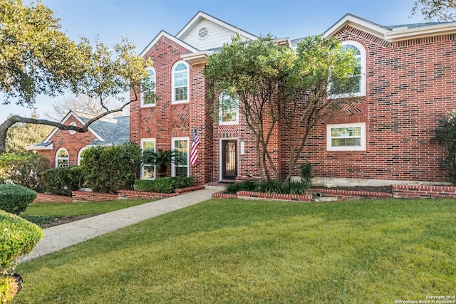 view of front of property with brick siding and a front yard