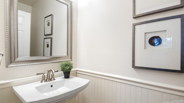 bathroom featuring a wainscoted wall and a sink