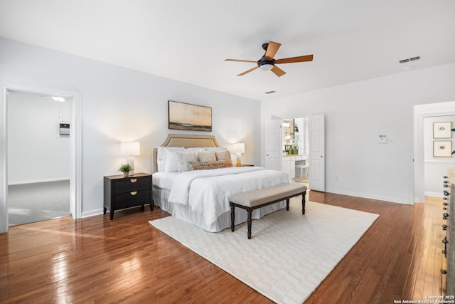 bedroom with visible vents, ceiling fan, baseboards, and wood-type flooring