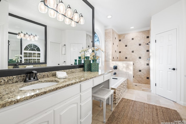 full bathroom featuring vanity, a garden tub, a healthy amount of sunlight, and a shower stall