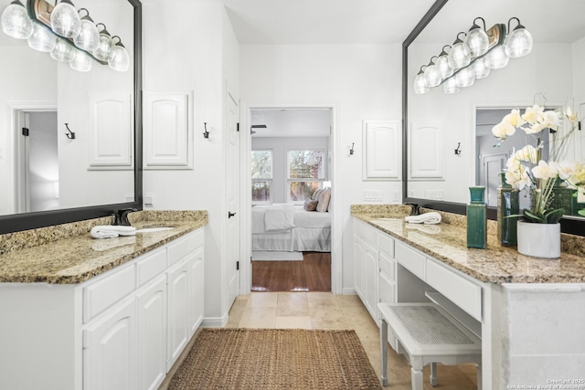 ensuite bathroom featuring connected bathroom, vanity, and tile patterned flooring