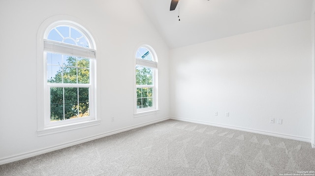 spare room featuring high vaulted ceiling, a ceiling fan, baseboards, and light carpet