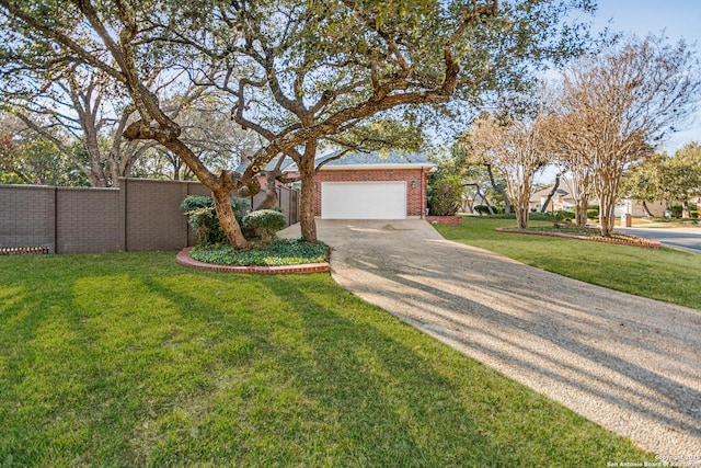 view of front of property with a front yard, fence, an attached garage, concrete driveway, and brick siding