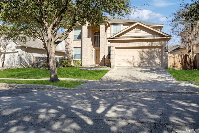 traditional home with fence, driveway, an attached garage, a front lawn, and brick siding