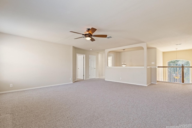 unfurnished room with visible vents, a ceiling fan, baseboards, and carpet floors