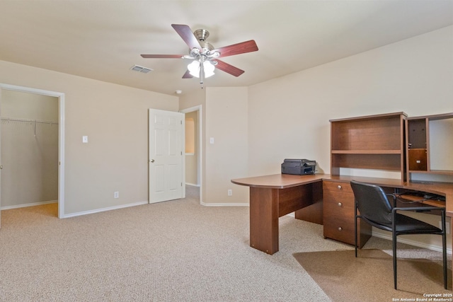 office space with ceiling fan, baseboards, visible vents, and light carpet