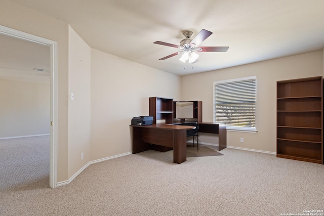 carpeted office space featuring visible vents, baseboards, and a ceiling fan