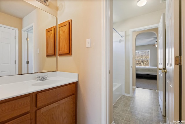 full bathroom with connected bathroom, vanity, and washtub / shower combination