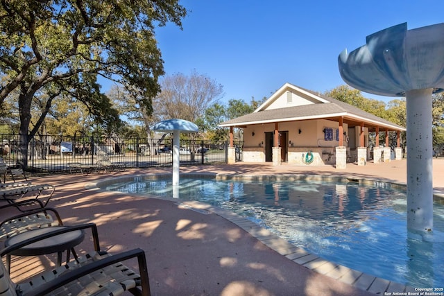 pool featuring a patio area and fence