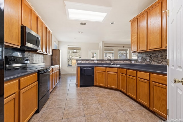 kitchen featuring dark countertops, visible vents, light tile patterned floors, black appliances, and a sink