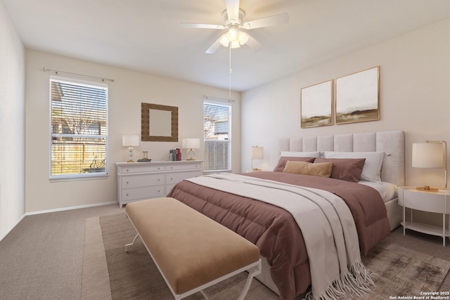 carpeted bedroom featuring a ceiling fan and baseboards