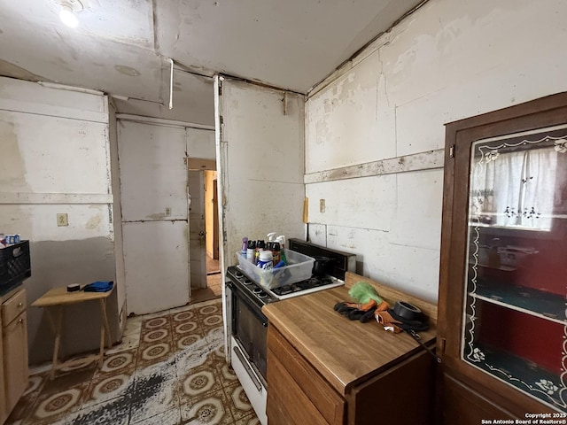 kitchen featuring white range with gas stovetop