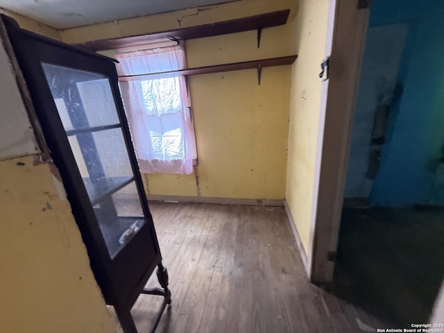 unfurnished bedroom featuring baseboards and wood finished floors