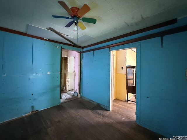 spare room with a ceiling fan, lofted ceiling, and wood finished floors