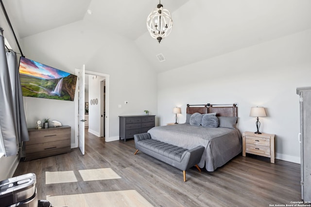 bedroom featuring visible vents, a notable chandelier, high vaulted ceiling, wood finished floors, and baseboards