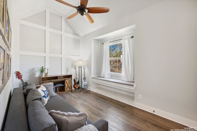 living area with baseboards, high vaulted ceiling, wood finished floors, and a ceiling fan