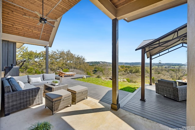 view of patio with an outdoor living space, a deck, and ceiling fan