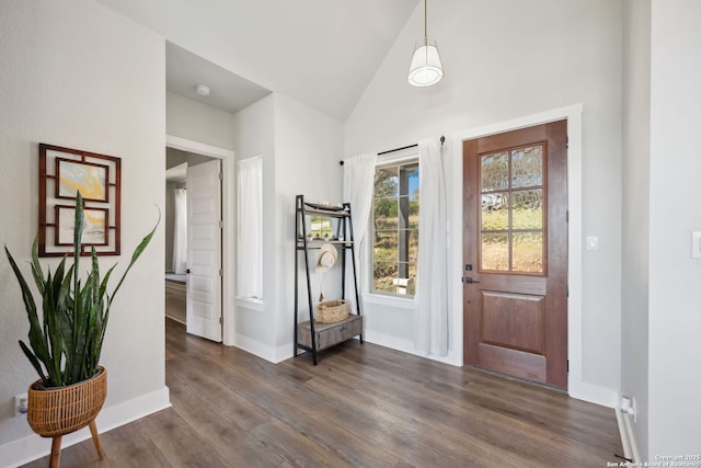 foyer featuring high vaulted ceiling, dark wood-type flooring, and baseboards