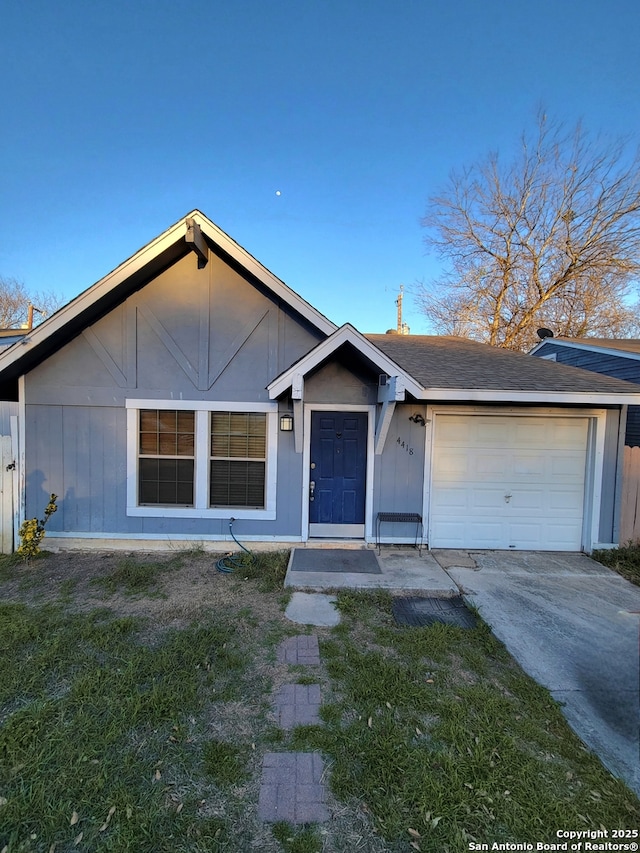 single story home featuring concrete driveway, an attached garage, and board and batten siding