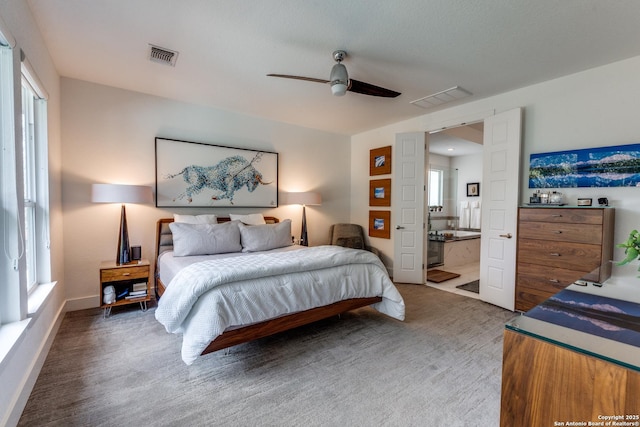 carpeted bedroom with visible vents, baseboards, and ceiling fan