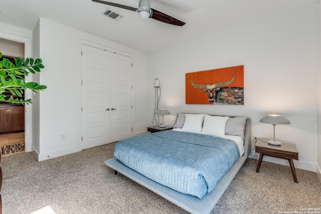 carpeted bedroom with a closet, visible vents, ceiling fan, and baseboards