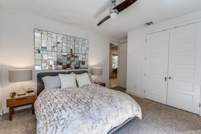 carpeted bedroom featuring visible vents, baseboards, a closet, and a ceiling fan