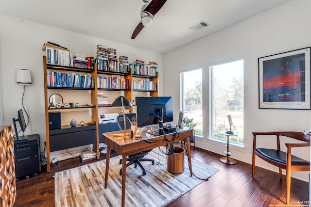 office space with ceiling fan, visible vents, baseboards, and wood finished floors