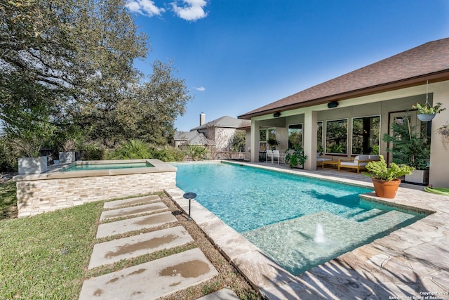 pool featuring an in ground hot tub, outdoor lounge area, and a patio