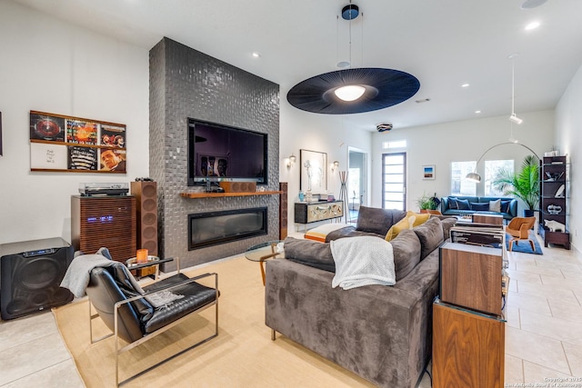 living room featuring tile patterned floors, recessed lighting, and a fireplace