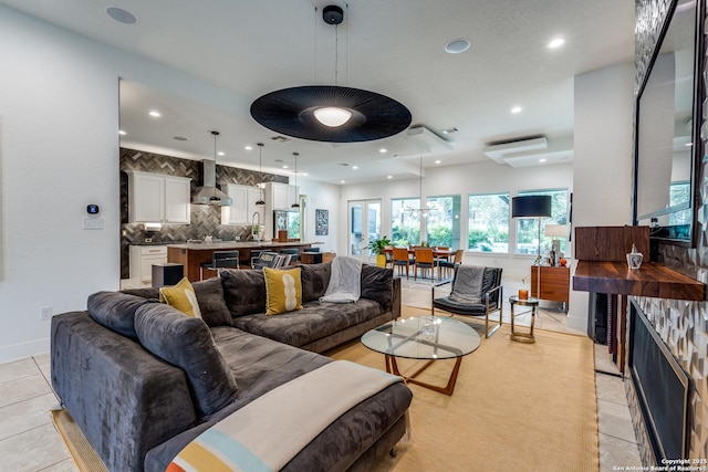 living area with a fireplace, light tile patterned floors, recessed lighting, and baseboards