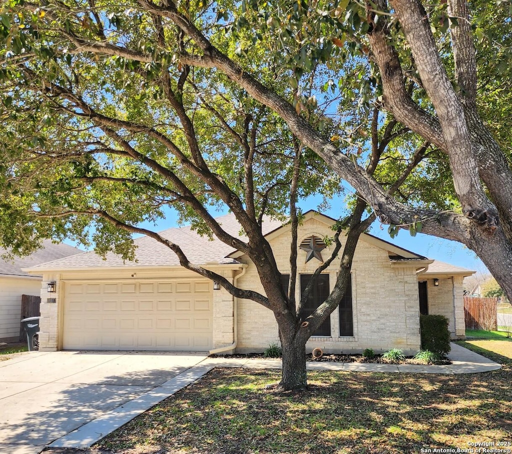 ranch-style house with brick siding, a garage, and concrete driveway