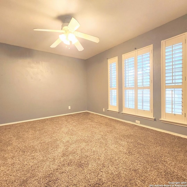 unfurnished room featuring baseboards, ceiling fan, and carpet flooring