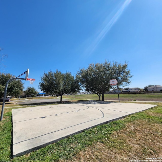 view of sport court with community basketball court and a lawn