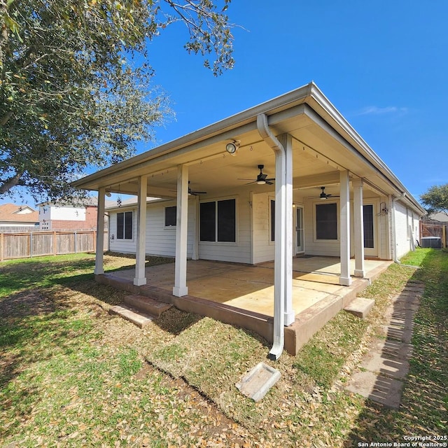 rear view of property with a patio area, a lawn, ceiling fan, and fence