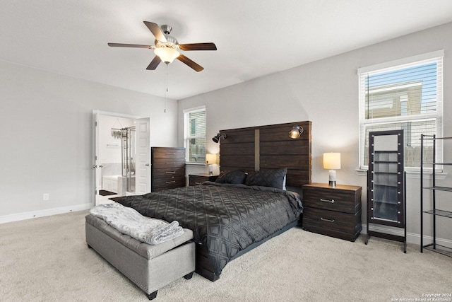 carpeted bedroom with ceiling fan and baseboards