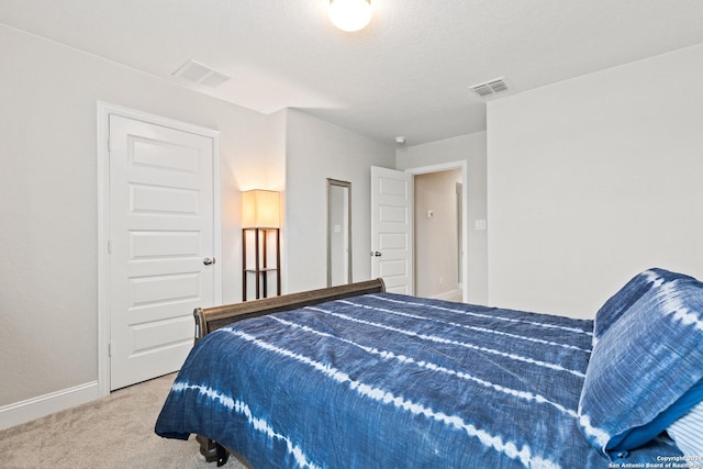 carpeted bedroom featuring visible vents and baseboards