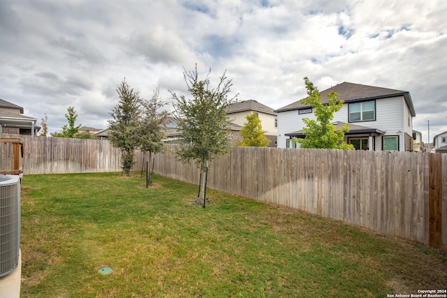 view of yard featuring central air condition unit and a fenced backyard