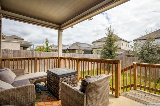 wooden terrace featuring a residential view and a fenced backyard