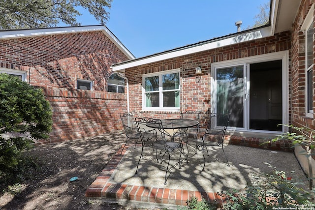 view of patio with outdoor dining space and fence