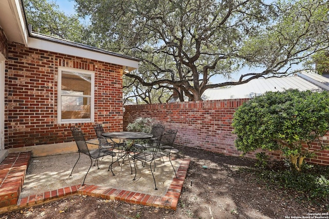 view of patio / terrace with outdoor dining space and fence