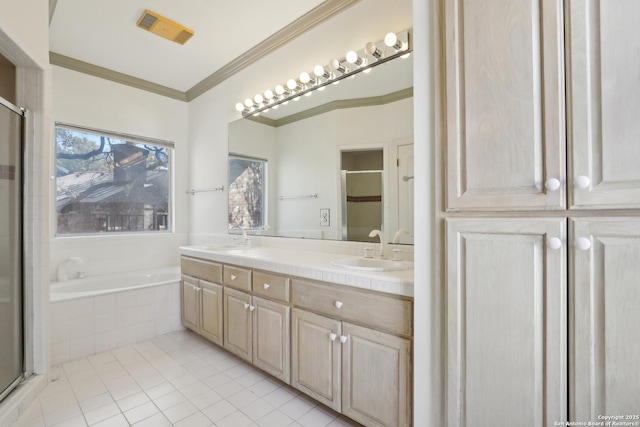 bathroom featuring visible vents, crown molding, a stall shower, a bath, and a sink