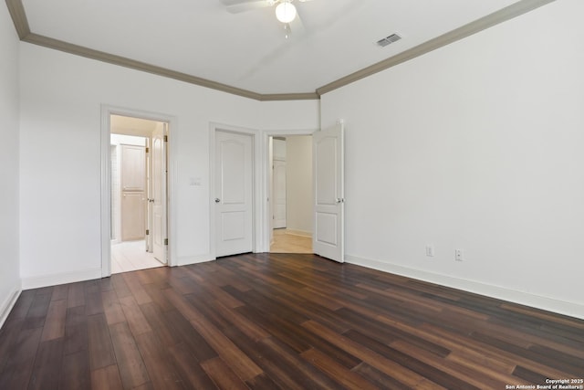 unfurnished bedroom with visible vents, baseboards, wood finished floors, and crown molding