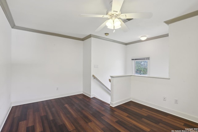 spare room with a ceiling fan, dark wood-type flooring, baseboards, and ornamental molding