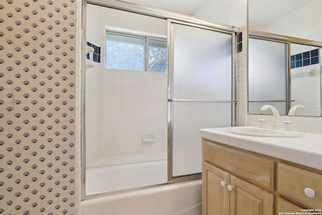 full bathroom featuring vanity and shower / bath combination with glass door