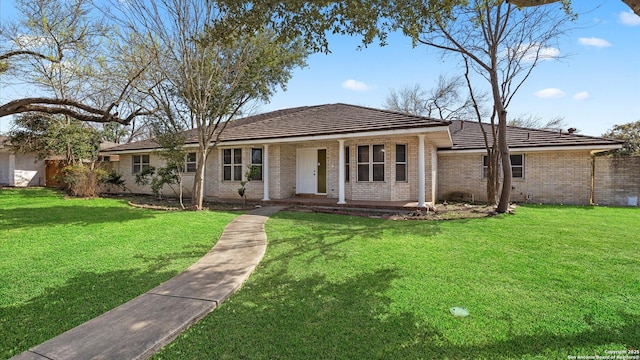 single story home featuring a front yard, a porch, and brick siding